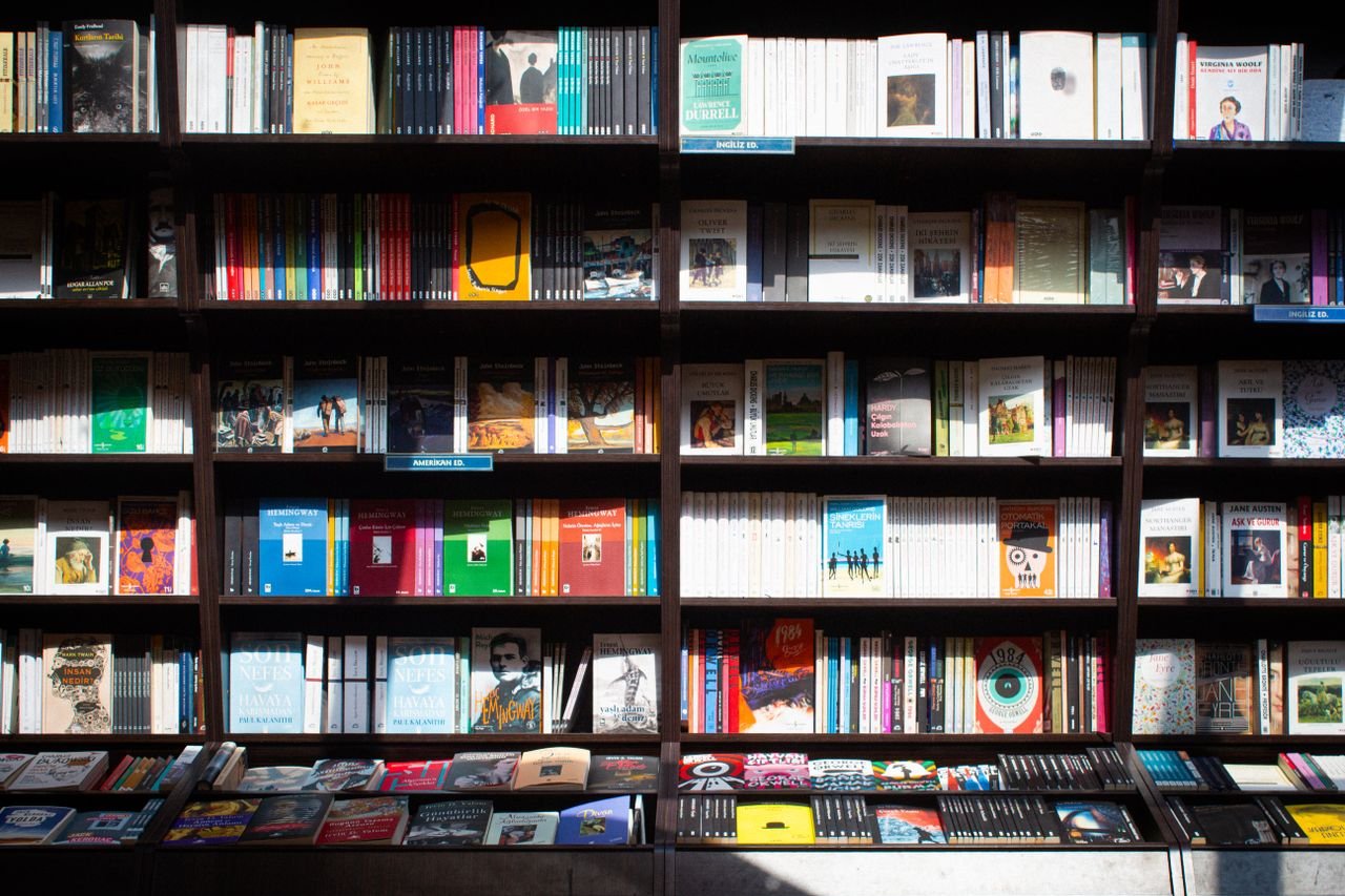 our-services-1 Wide array of books on a shelf in a cozy bookstore in Ankara, Türkiye.